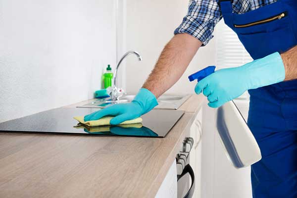 Cleaning a kitchen counter with solution